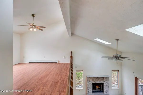 a view of a room with wooden floor and bench