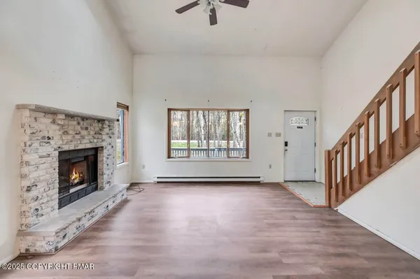 an empty room with windows and a fireplace