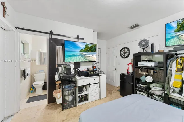 a view of a livingroom with furniture and a flat screen tv
