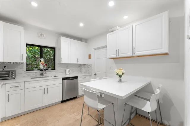 a kitchen with a sink cabinets and window