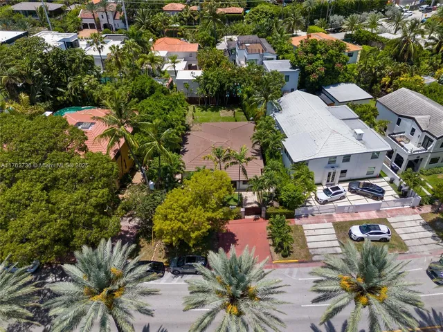 an aerial view of a houses with yard