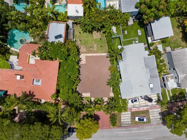 an aerial view of a house with a yard and garden