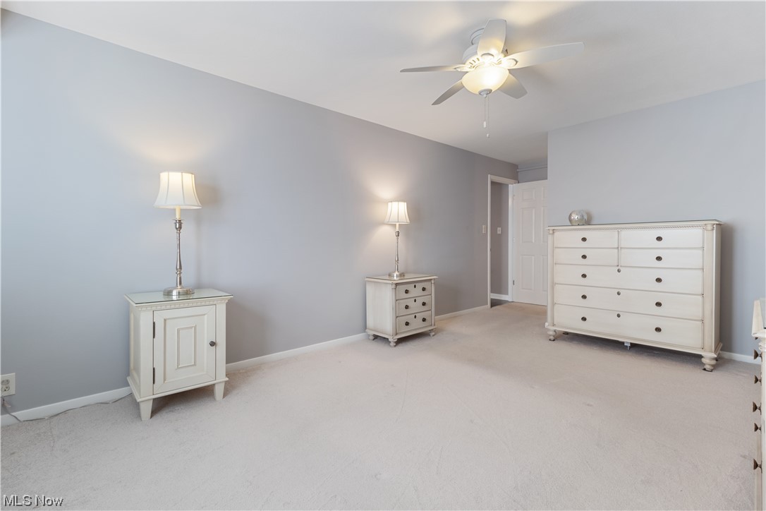 22555 Center Ridge Road, Unit 303 Rocky River, OH 44116 - Photo 20 of 33 Master bedroom featuring light carpet and ceiling fan