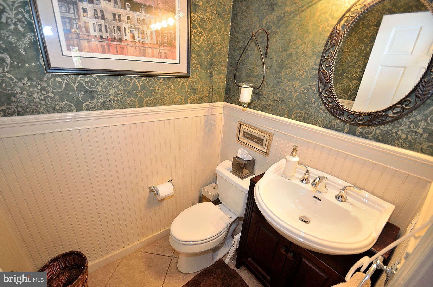 8521 Forrester Boulevard Springfield, VA 22152 - Photo 11 of 28 a bathroom with a sink mirror and toilet