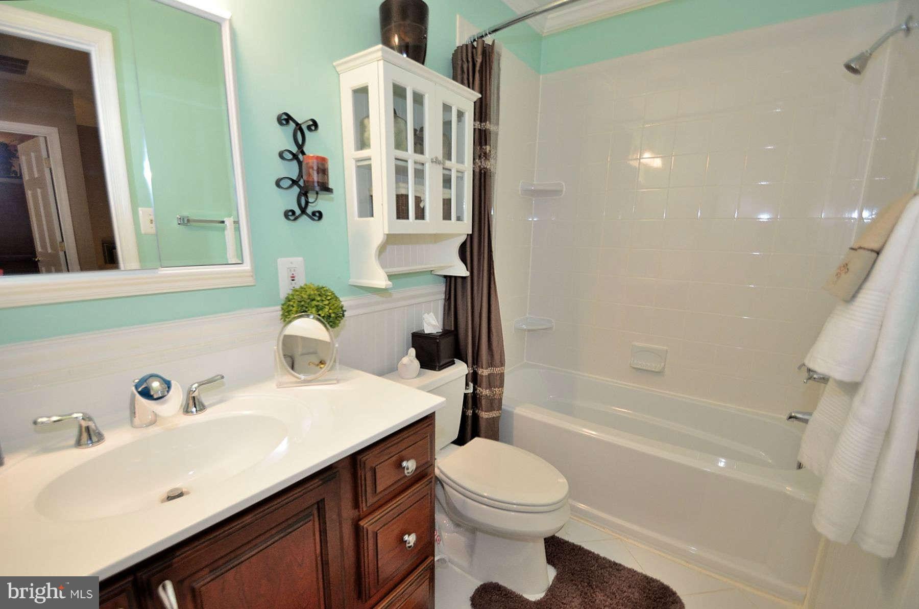 8521 Forrester Boulevard Springfield, VA 22152 - Photo 15 of 28 a bathroom with a sink a toilet and shower
