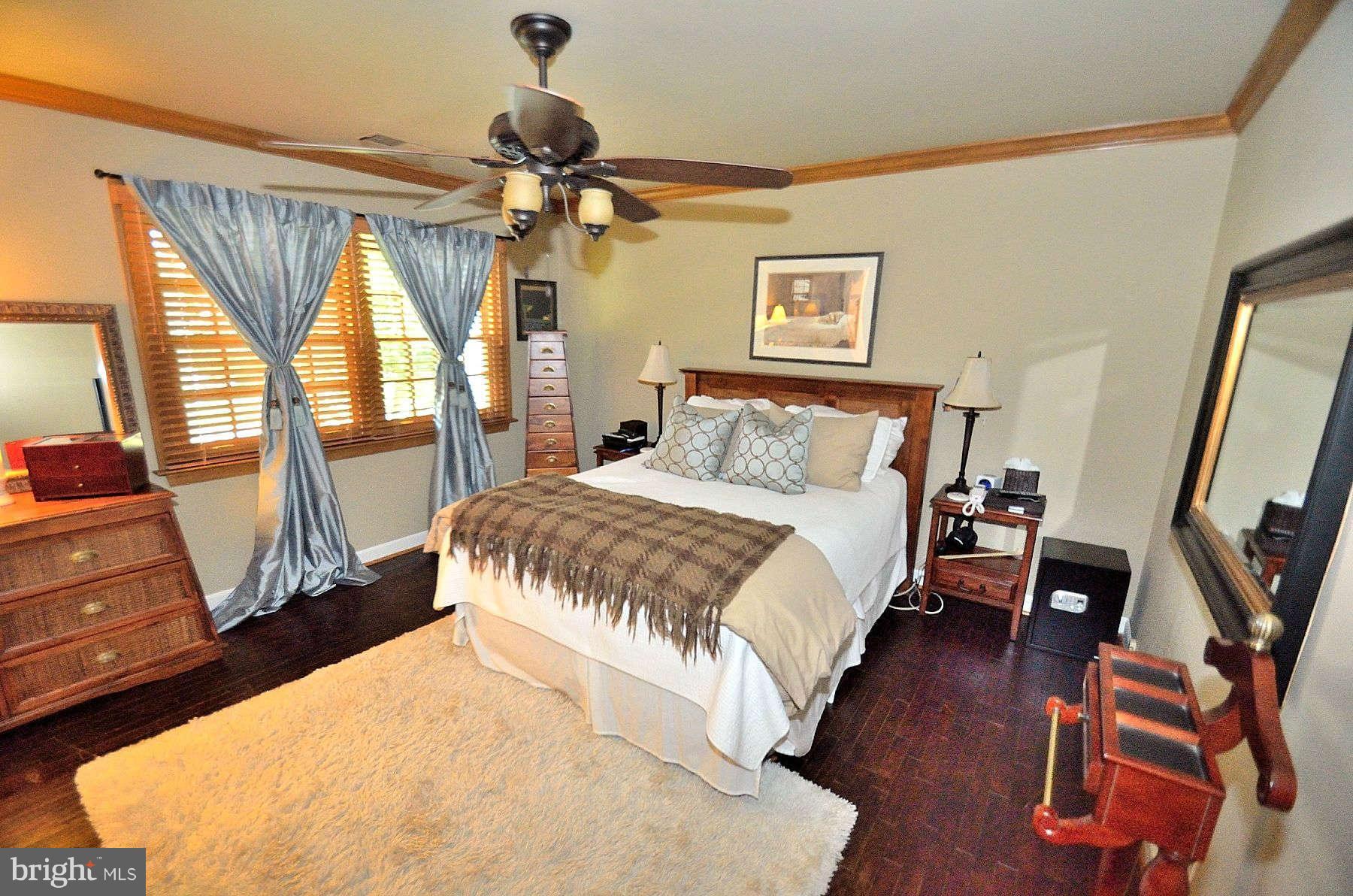 8521 Forrester Boulevard Springfield, VA 22152 - Photo 17 of 28 a bedroom with a large bed and a flat tv screen on dresser