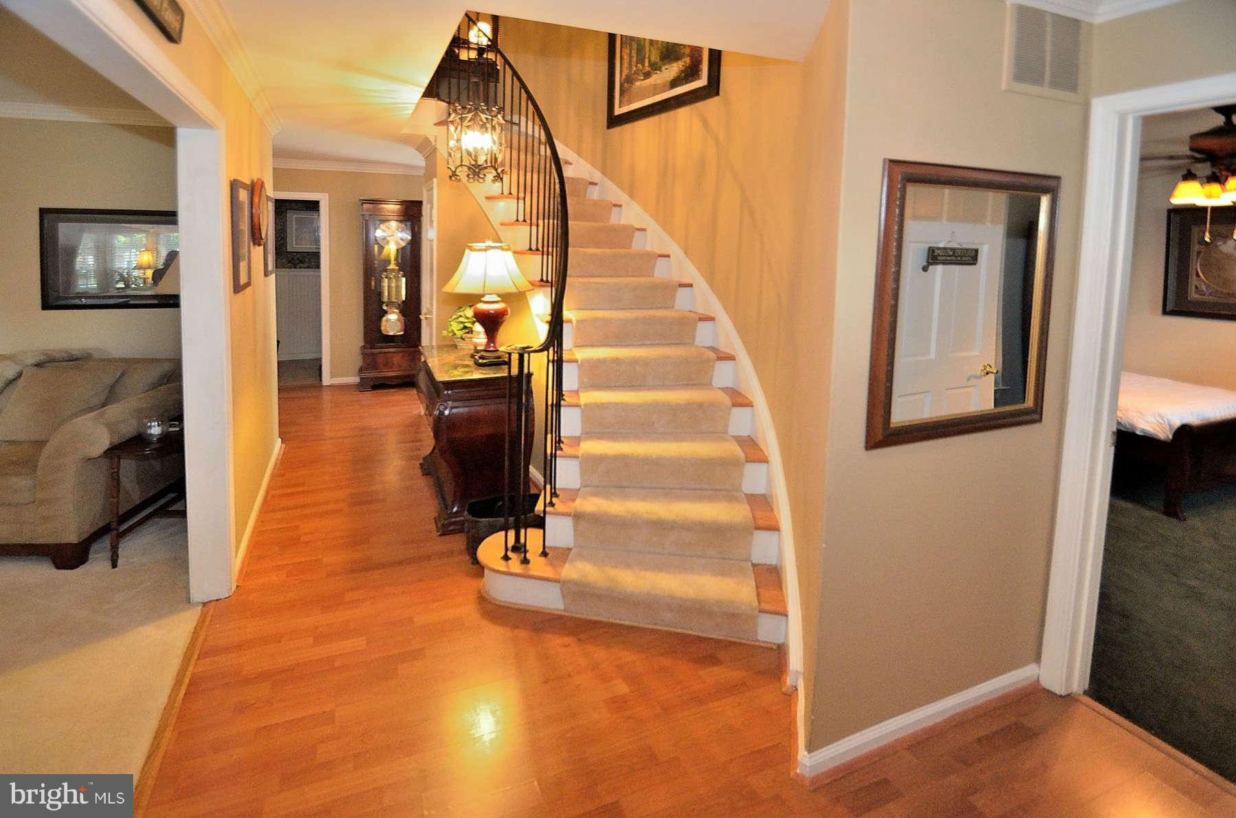 8521 Forrester Boulevard Springfield, VA 22152 - Photo 3 of 28 a view of a hallway with wooden floor and staircase