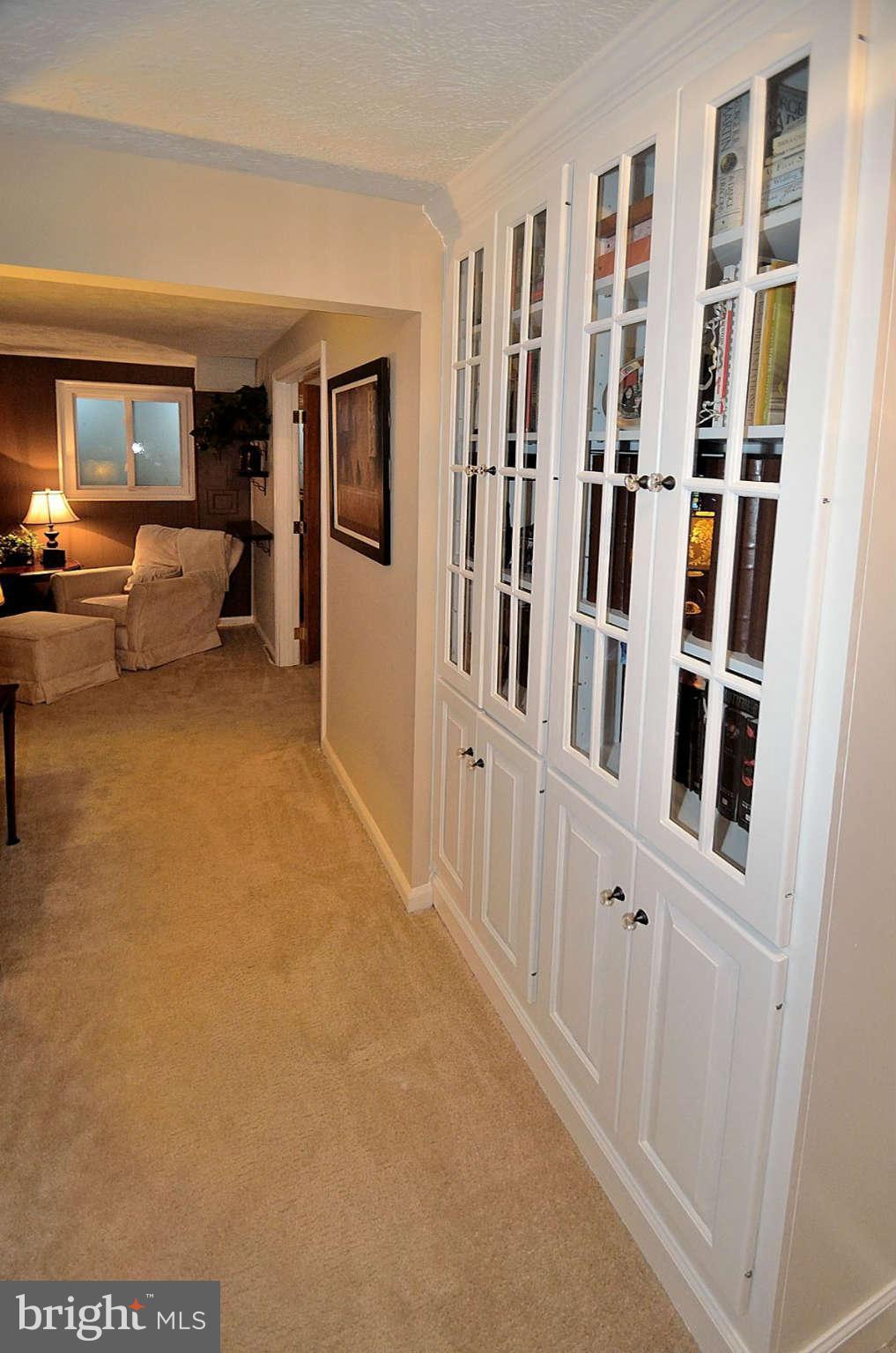 8521 Forrester Boulevard Springfield, VA 22152 - Photo 21 of 28 a living room with furniture and a book shelf