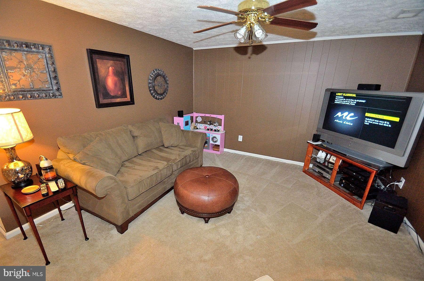 8521 Forrester Boulevard Springfield, VA 22152 - Photo 23 of 28 a living room with furniture and a flat screen tv