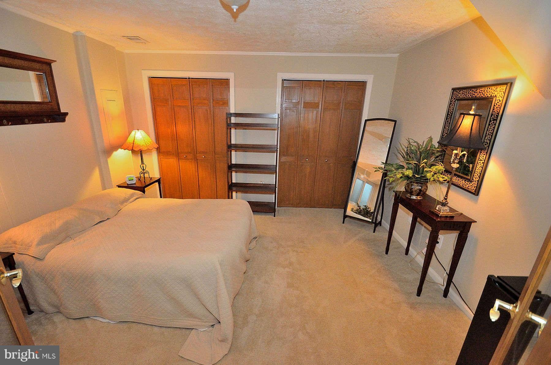 8521 Forrester Boulevard Springfield, VA 22152 - Photo 24 of 28 a bedroom with a bed and dresser with mirror