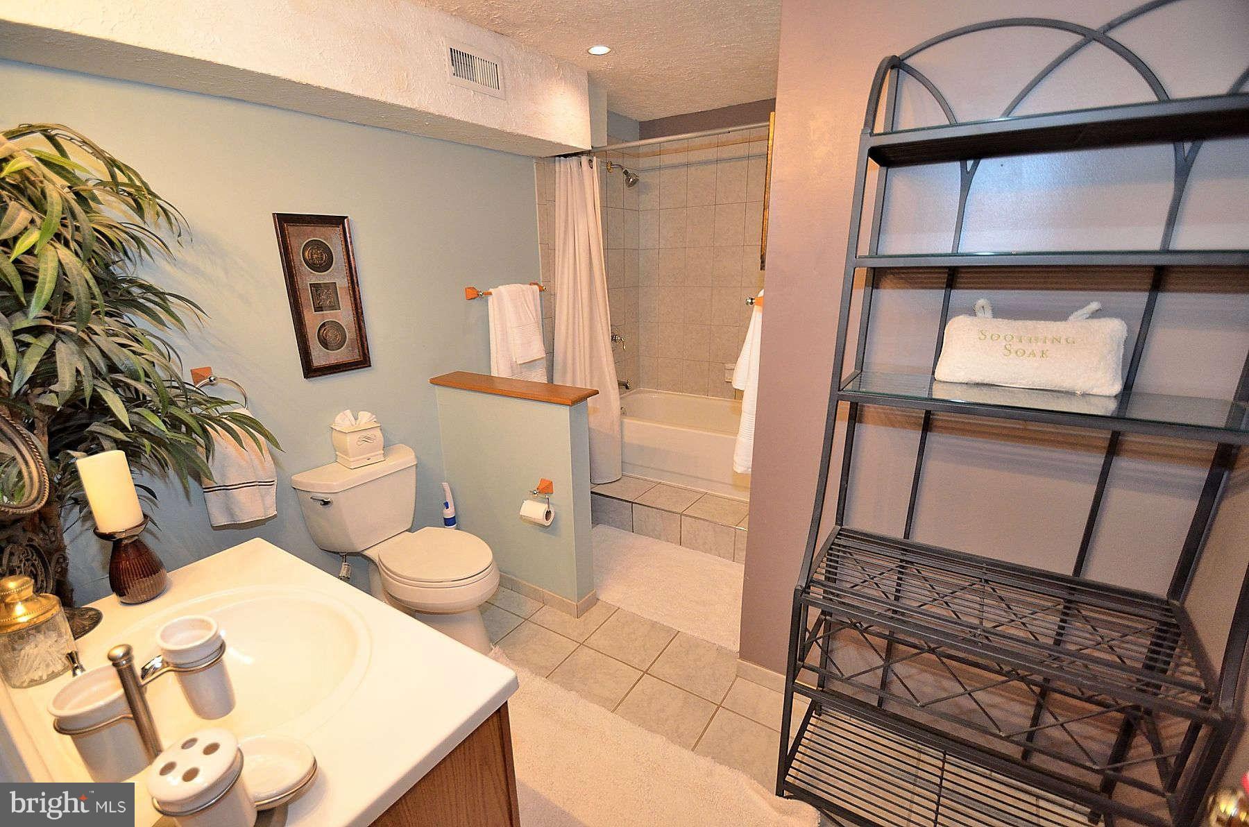 8521 Forrester Boulevard Springfield, VA 22152 - Photo 25 of 28 a bathroom with a granite countertop sink mirror vanity and toilet