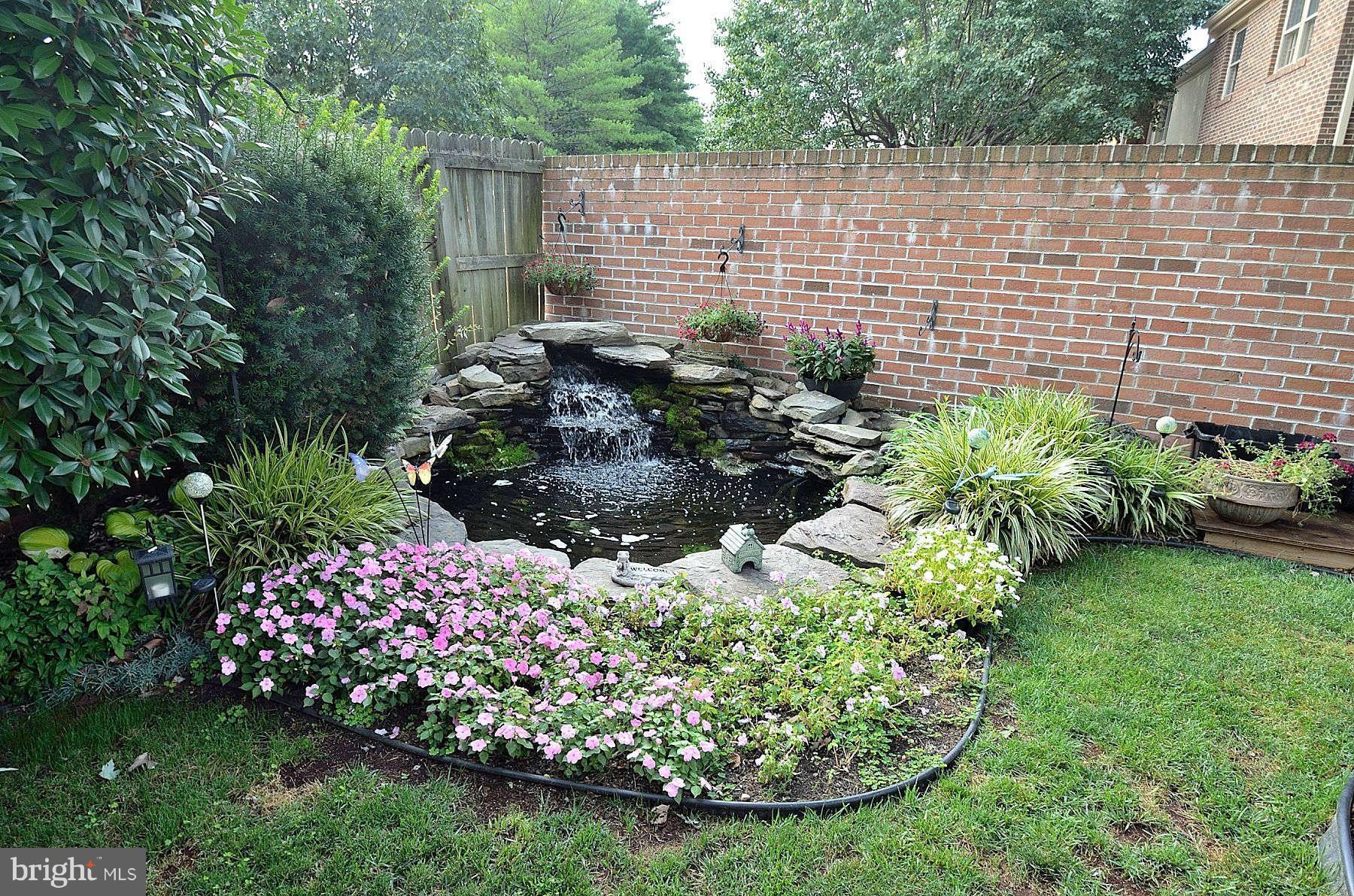 8521 Forrester Boulevard Springfield, VA 22152 - Photo 27 of 28 a view of a garden with a fountain
