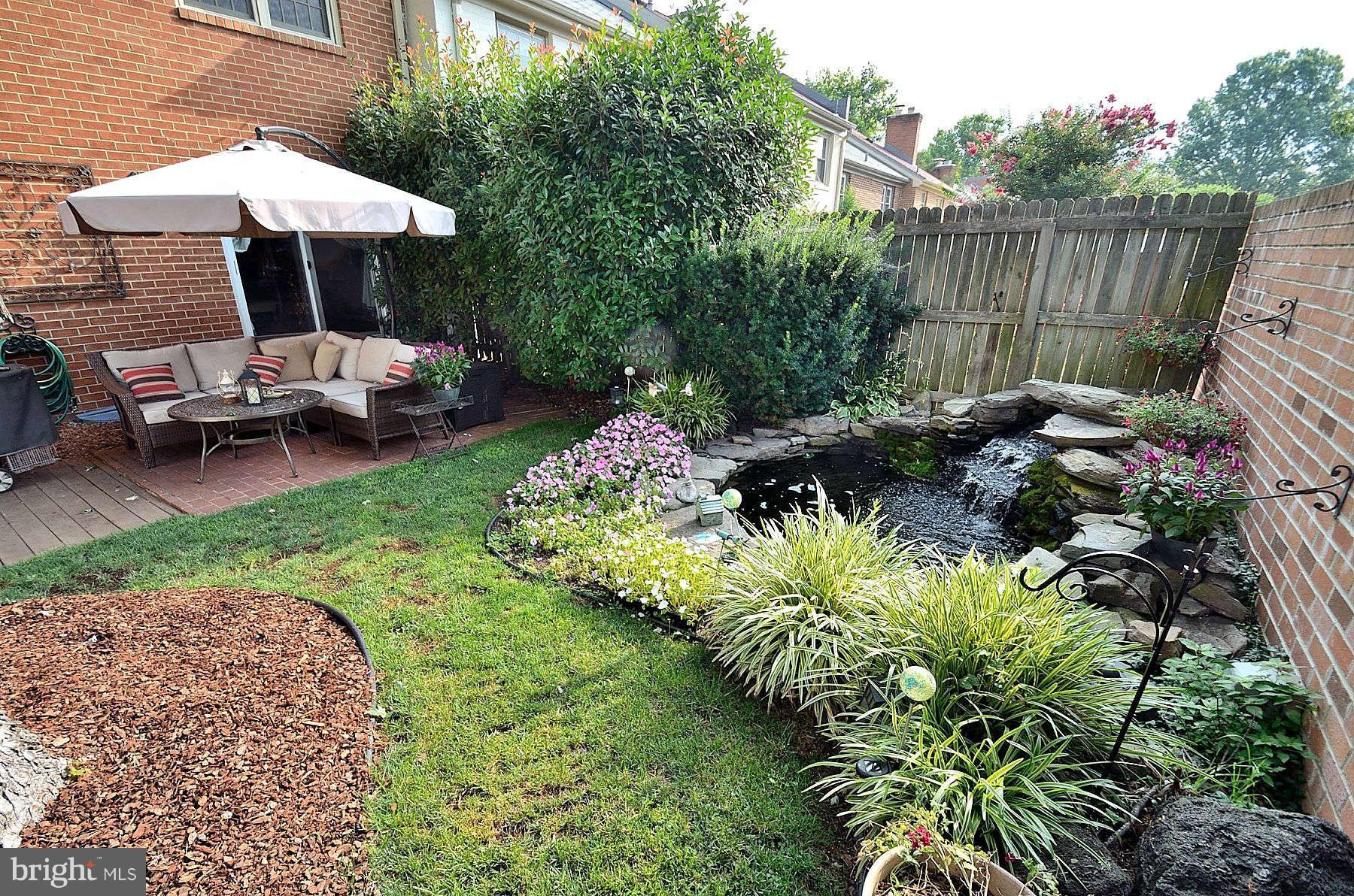 8521 Forrester Boulevard Springfield, VA 22152 - Photo 28 of 28 a view of a backyard with plants and patio
