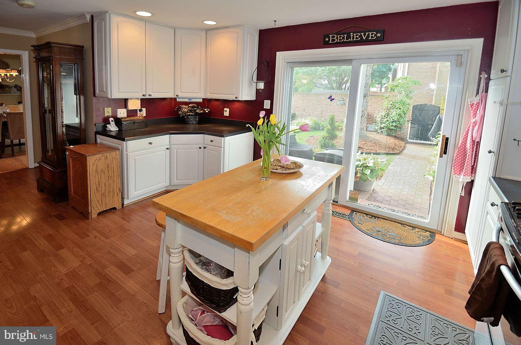 8521 Forrester Boulevard Springfield, VA 22152 - Photo 7 of 28 a kitchen with stainless steel appliances granite countertop a stove a sink and a microwave