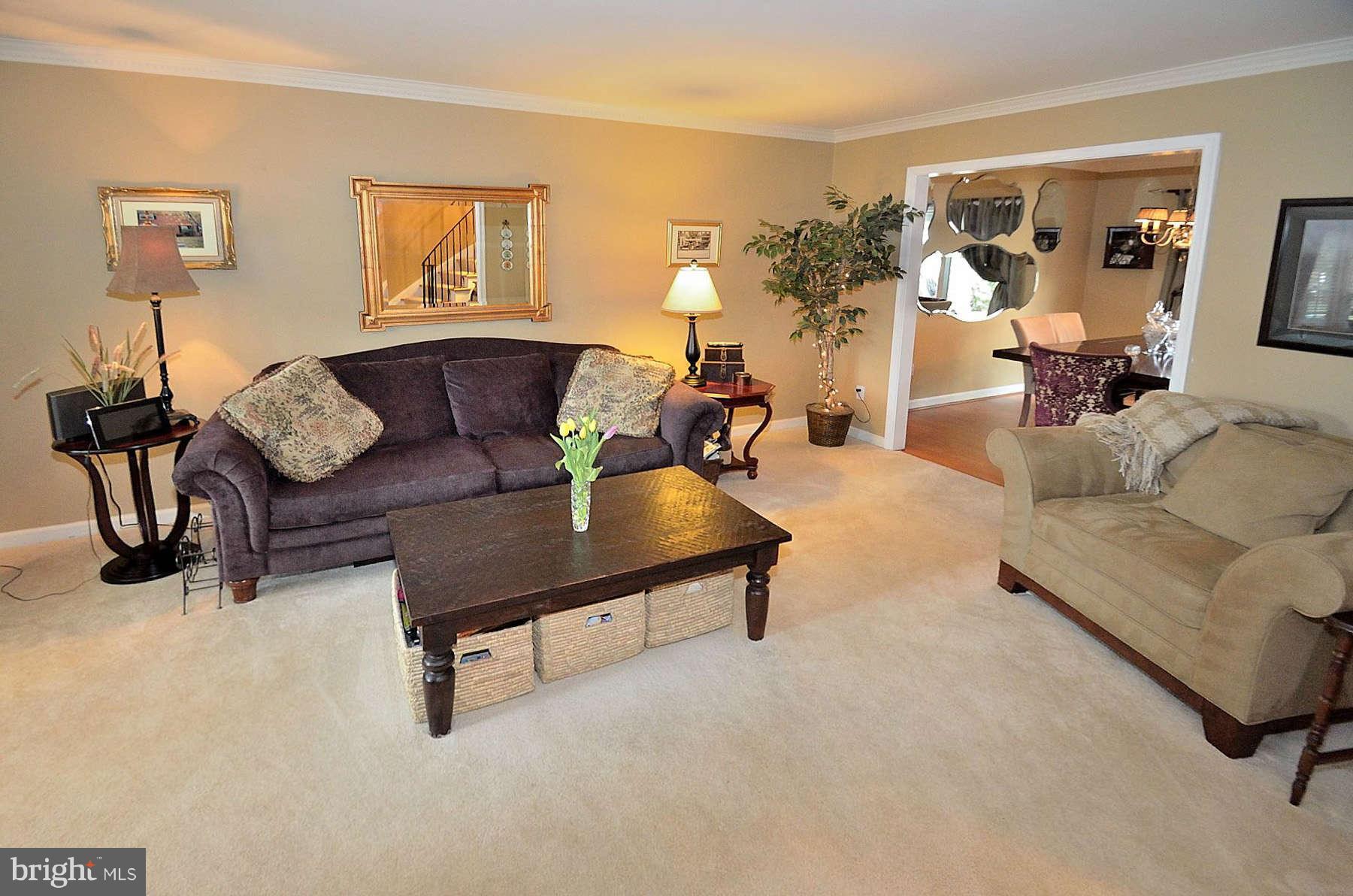 8521 Forrester Boulevard Springfield, VA 22152 - Photo 8 of 28 a living room with furniture and a lamp