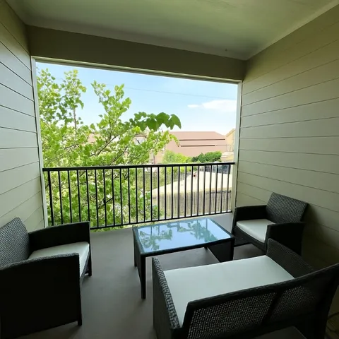 a balcony view with a seating space