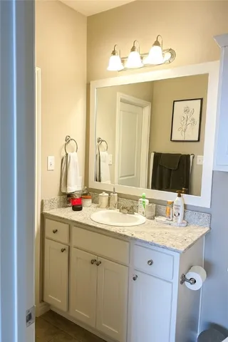 a bathroom with a double vanity sink and a mirror