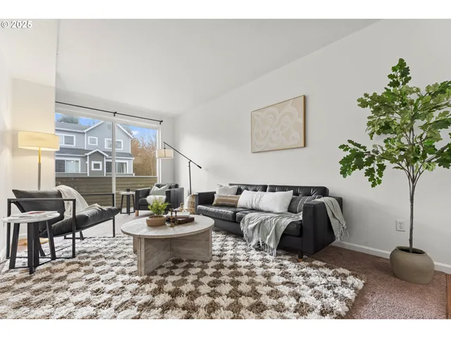 a living room with furniture and a potted plant