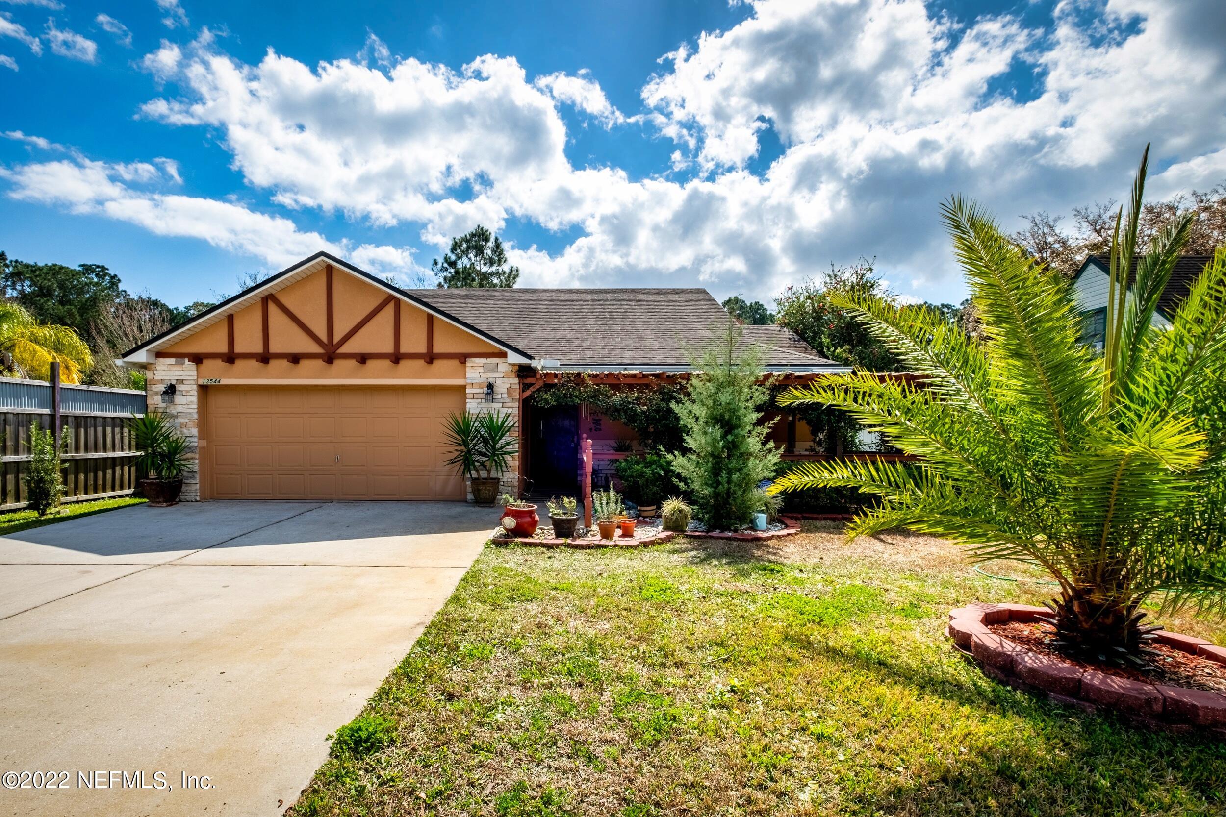 a view of house with yard and entertaining space