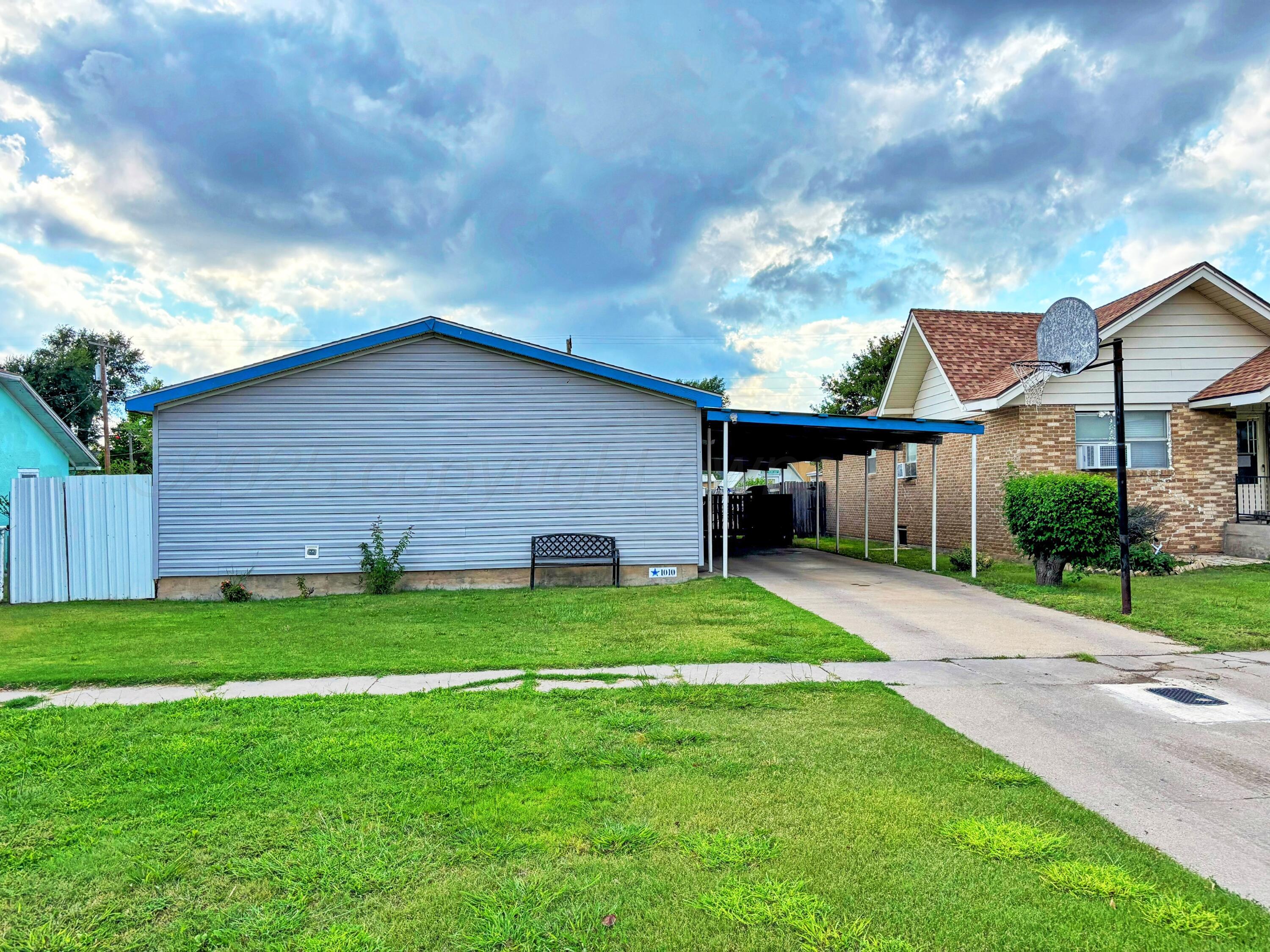 1010 South Baylor Street Perryton, TX 79070 - Photo 1 of 35 a backyard of a house with table and chairs