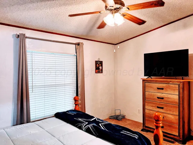 a bedroom with a bed and a painting on the wall