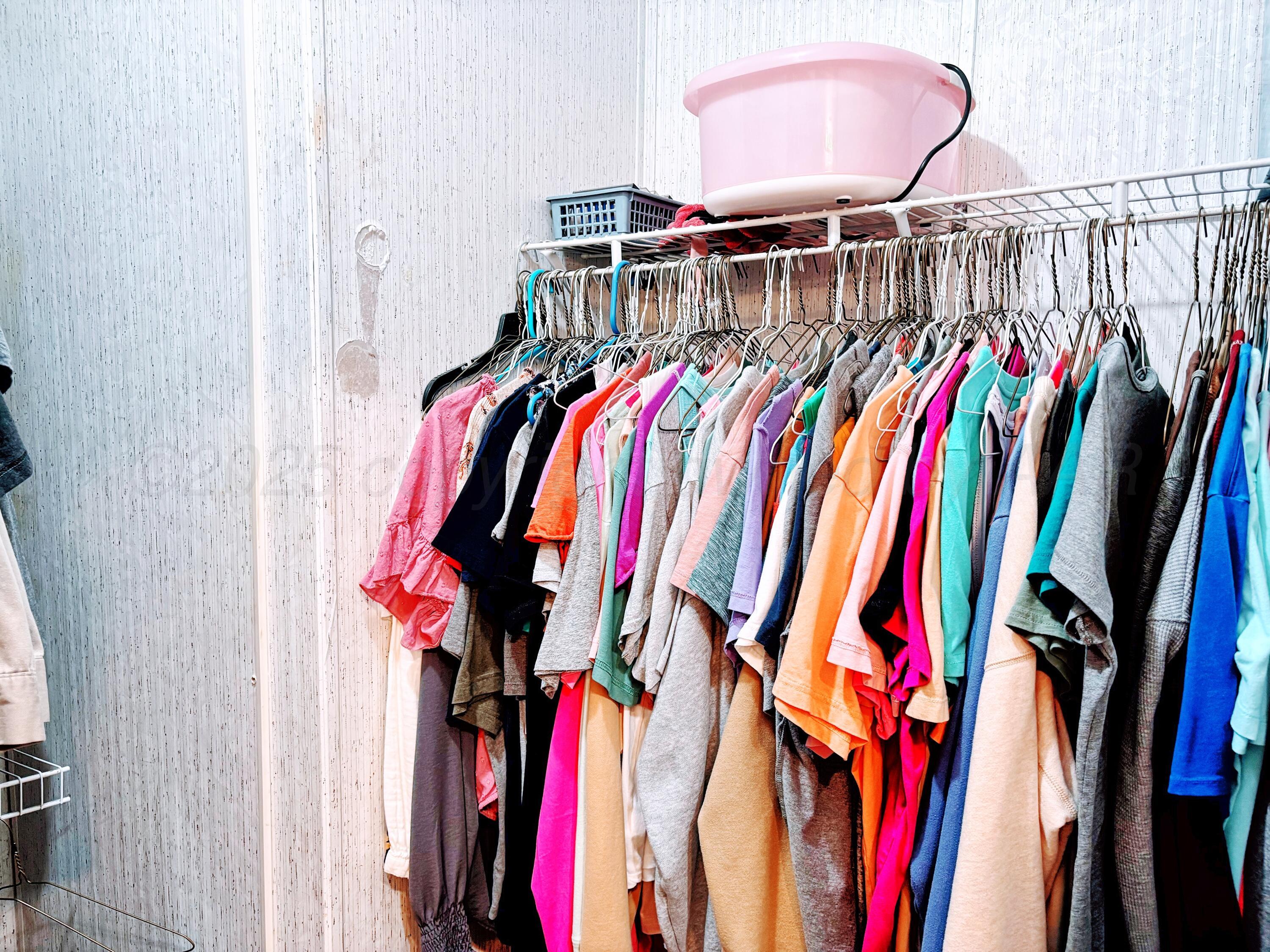 1010 South Baylor Street Perryton, TX 79070 - Photo 18 of 35 a view of walk in closet with clothes and shoes
