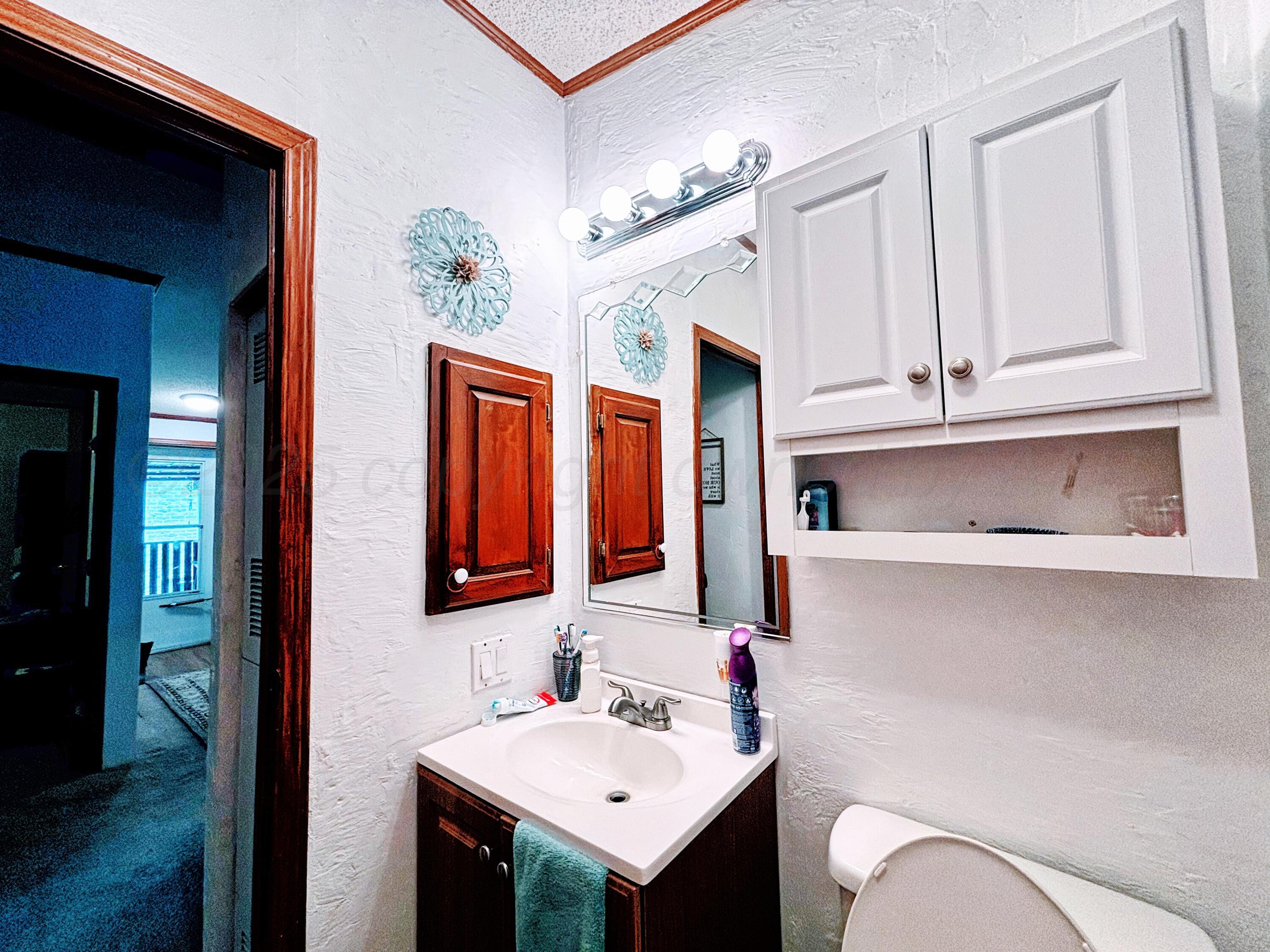 1010 South Baylor Street Perryton, TX 79070 - Photo 28 of 35 a bathroom with a sink and a mirror