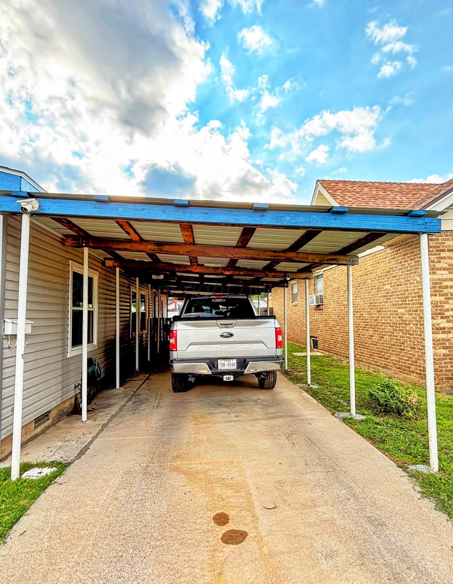 1010 South Baylor Street Perryton, TX 79070 - Photo 3 of 35 a view of parking garage with a car parked