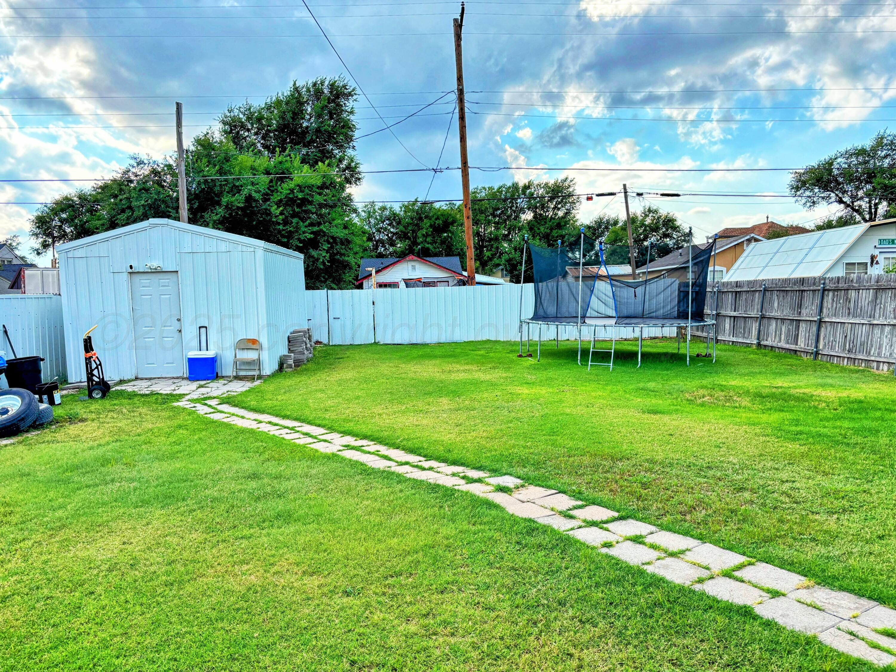1010 South Baylor Street Perryton, TX 79070 - Photo 31 of 35 a view of a house with a yard and sitting area