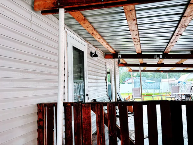 a front view of a house with wooden stairs