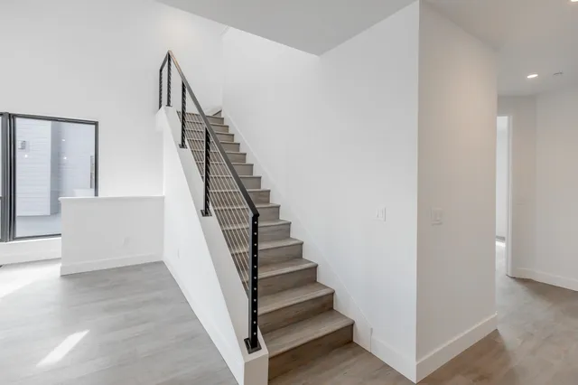 a view of entryway and hall with wooden floor