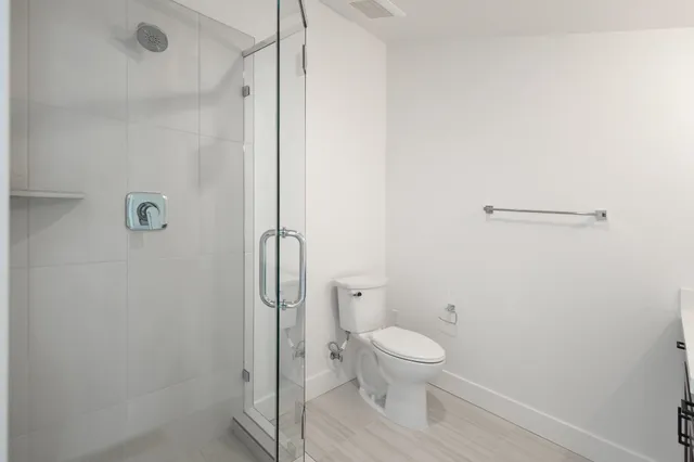 a bathroom with a toilet and a shower