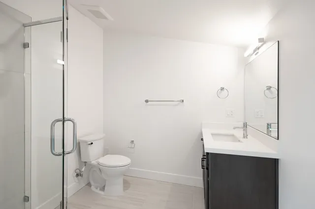 a bathroom with a toilet sink and shower