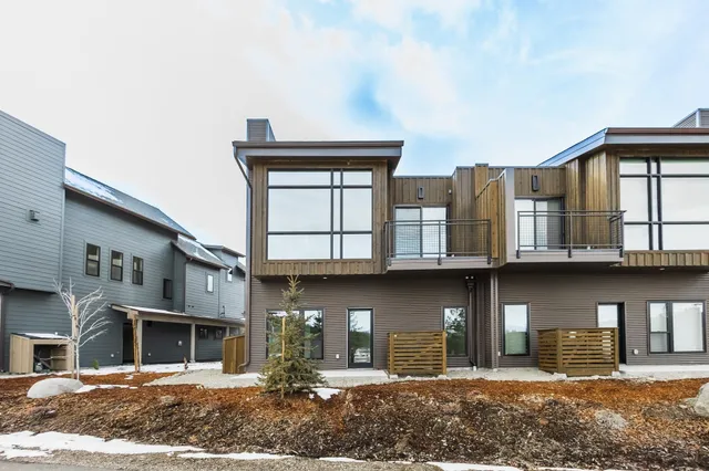a front view of a residential apartment building with a yard