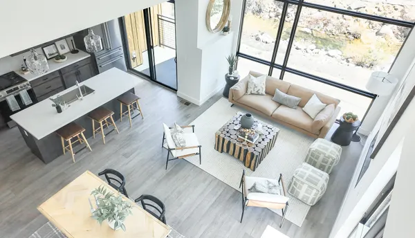 a living room with furniture and a floor to ceiling window