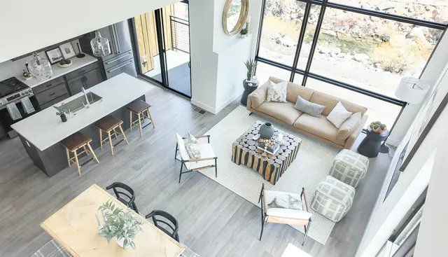 a living room with furniture and a floor to ceiling window