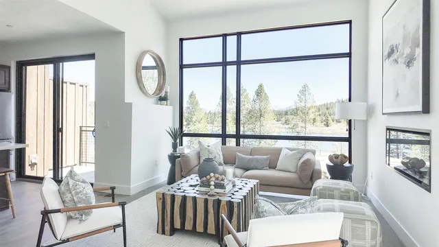 a living room with furniture and a large window