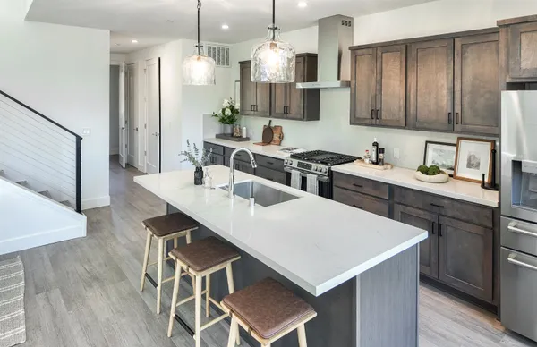 a kitchen with a table chairs sink and cabinets