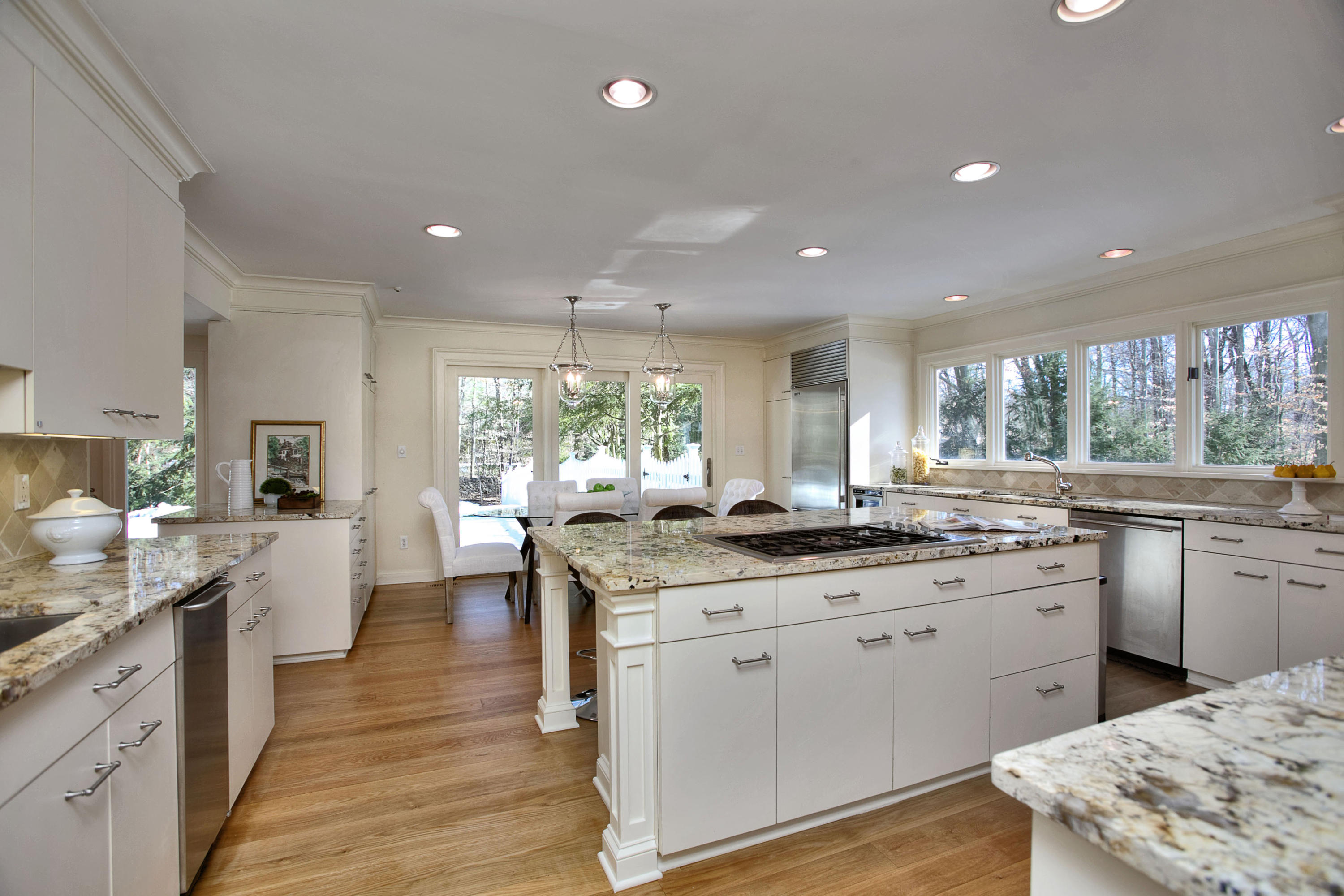 21 Indian Spring Trail Darien, CT 06820 - Photo 19 of 34 a kitchen with granite countertop a sink stove cabinets and wooden floor