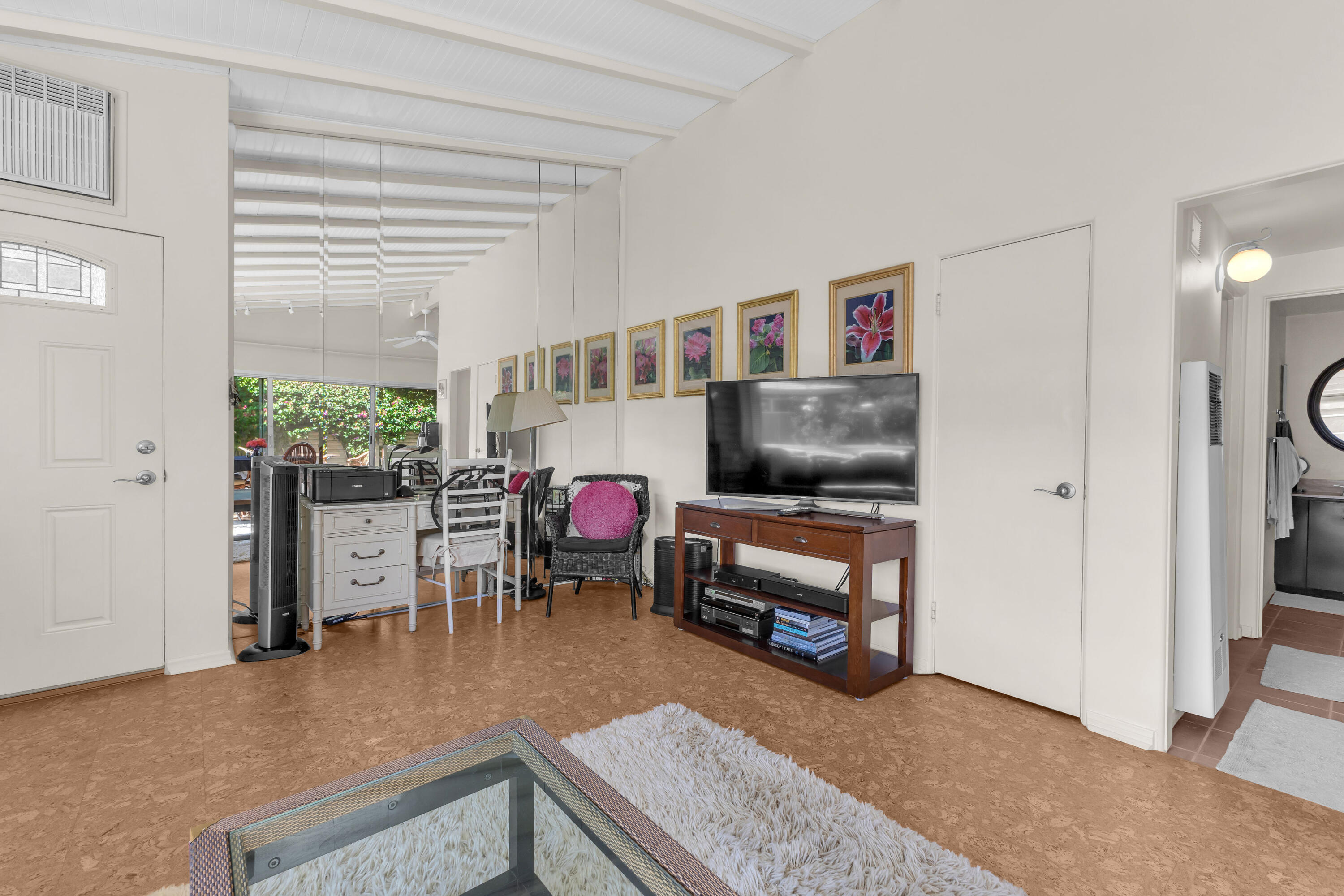 69850 Hwy 111 Rancho Mirage Ca, Unit 11 Rancho Mirage, CA 92270 - Photo 13 of 48 a living room with furniture and a flat screen tv