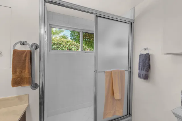 a bathroom with a shower and a window