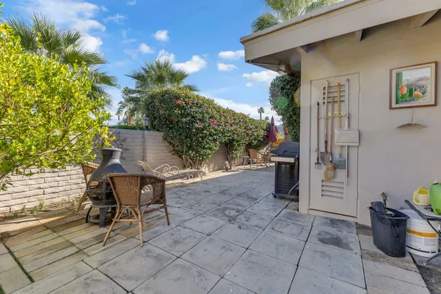 a view of a patio with table and chairs and potted plants
