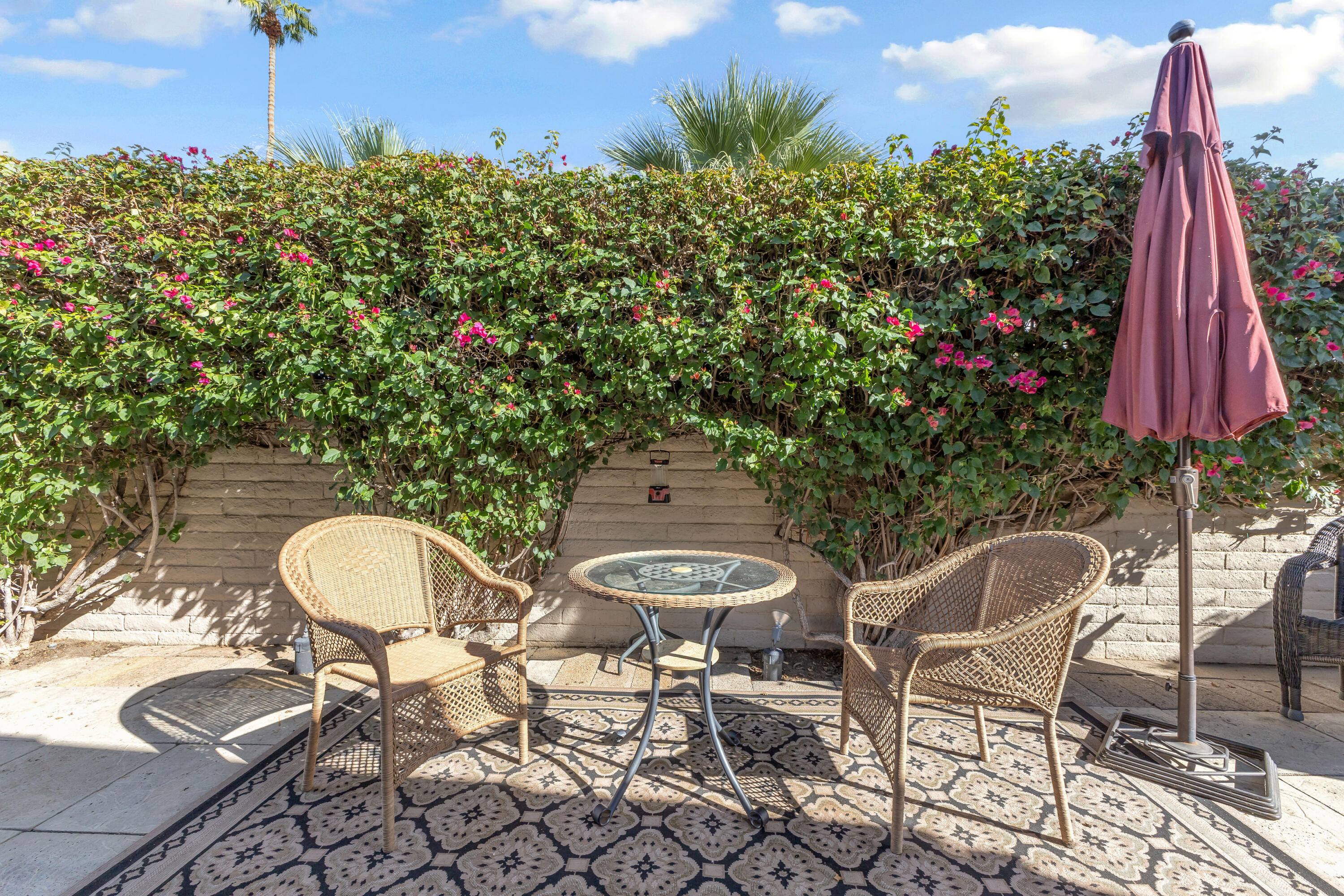 69850 Hwy 111 Rancho Mirage Ca, Unit 11 Rancho Mirage, CA 92270 - Photo 25 of 48 a view of a chairs and table in backyard