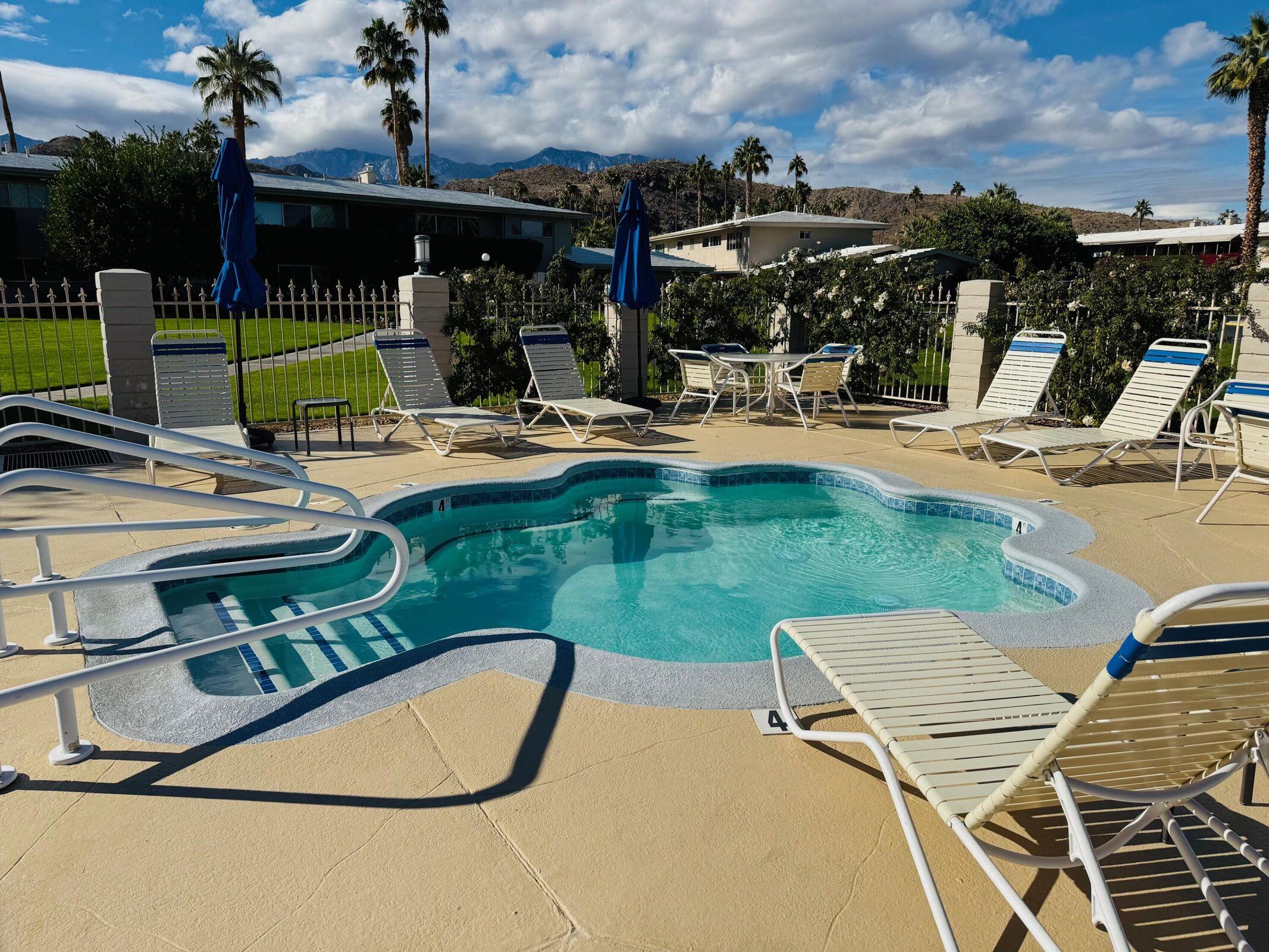 69850 Hwy 111 Rancho Mirage Ca, Unit 11 Rancho Mirage, CA 92270 - Photo 33 of 48 a view of a swimming pool with a patio and a yard