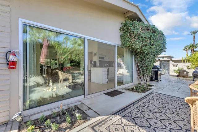 a room with lots of trees and furniture