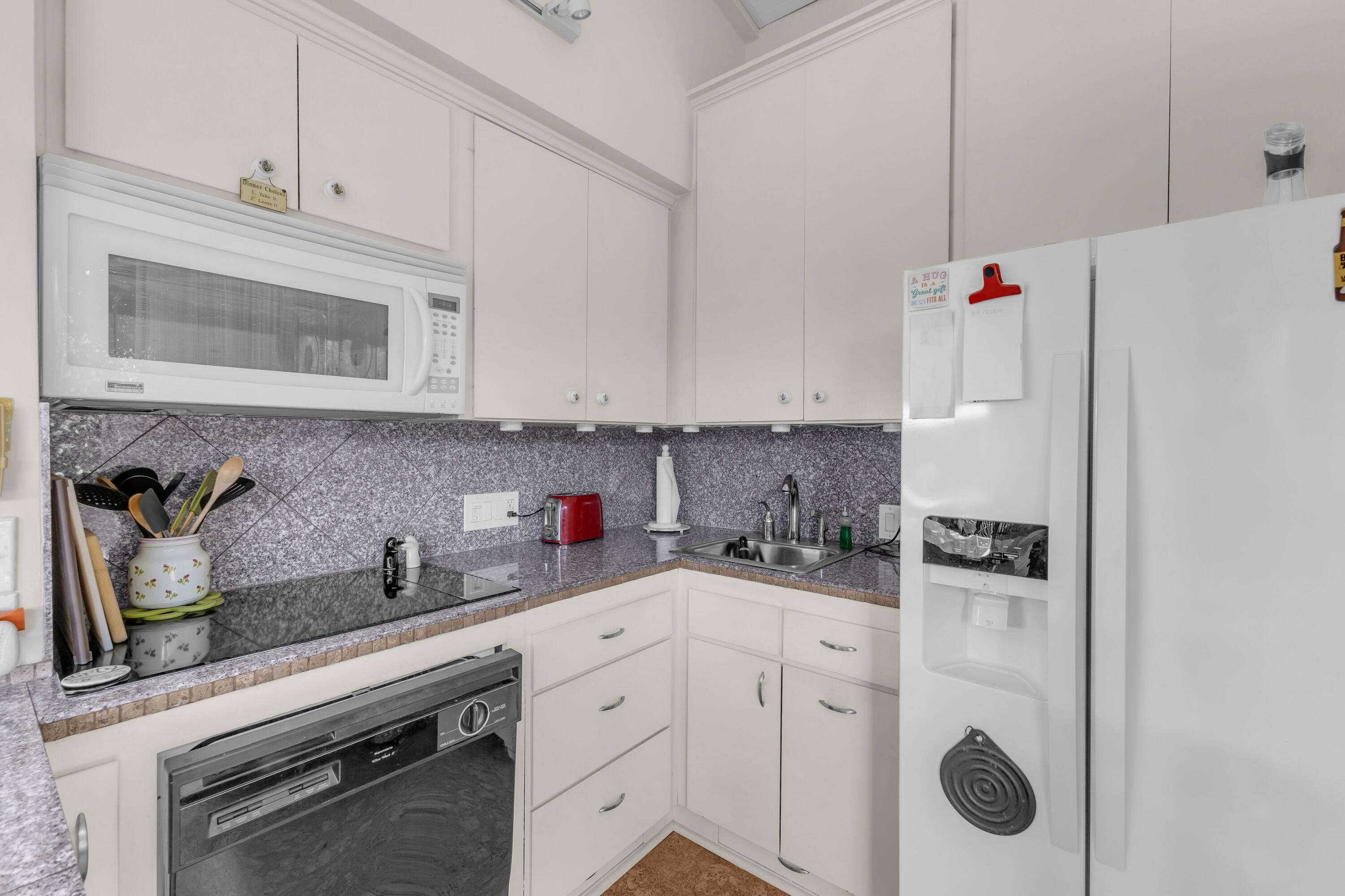 69850 Hwy 111 Rancho Mirage Ca, Unit 11 Rancho Mirage, CA 92270 - Photo 10 of 48 a kitchen with white cabinets and white appliances