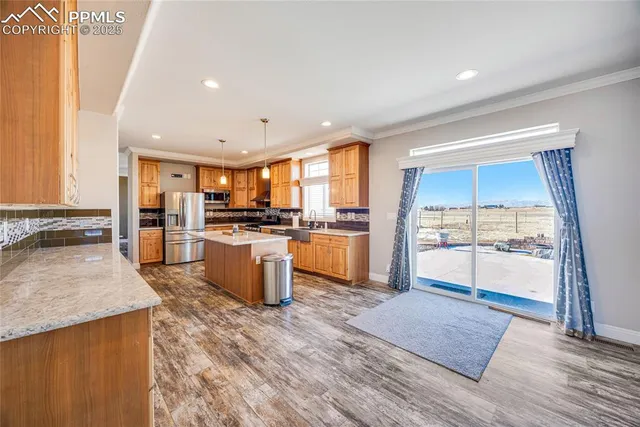 a large kitchen with cabinets and wooden floor