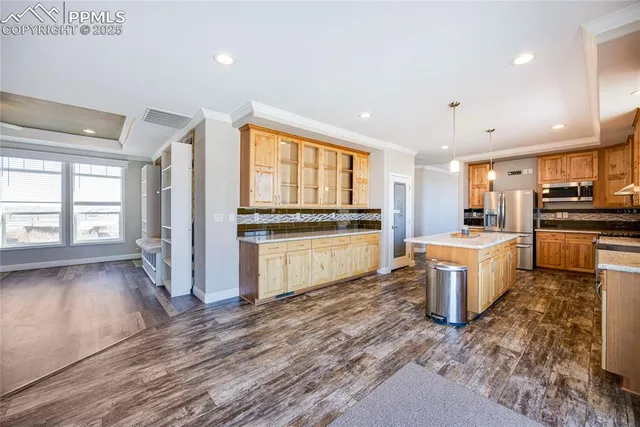 a large kitchen with a white stove top oven cabinets a sink and appliances