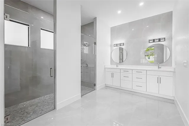 a spacious bathroom with a granite countertop sink mirror and shower
