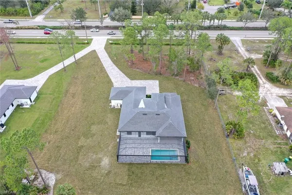 an aerial view of a house with a yard